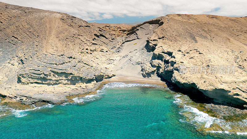 Aerial view of the hidden cove beach "La Rajita" at the natural reserve of "Monta?a Pelada" in Tenerife (Canary Islands). Drone shot